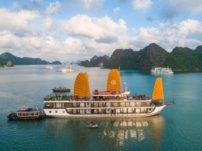 Cruise ship with orange sails in Ha Long Bay