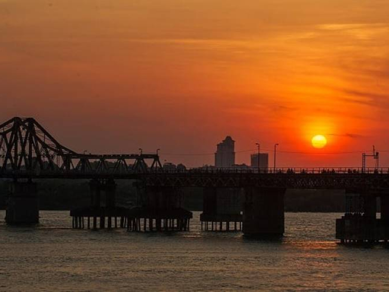 Long Bien Bridge silhouetted at sunset in Hanoi