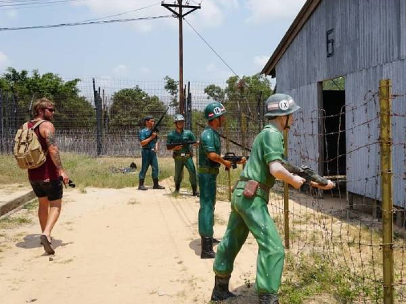 Phu Quoc Prison in the Idyllic Torture Island of Vietnam Traveler viewing life-size guard figures at Phu Quoc Prison museum