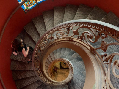 Ho Chi Minh City Museum of Fine Arts: History, Culture & Art Visitor on the ornate spiral staircase at the Ho Chi Minh City Museum of Fine Arts