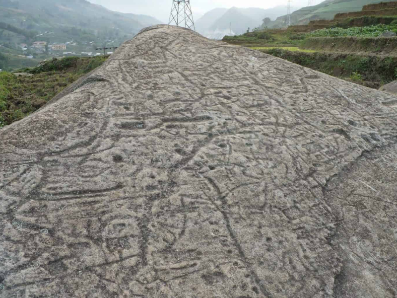 Close-up of mysterious carved lines and patterns on a stone at the Ancient Stone Field of Sapa Close-up of mysterious carved lines and patterns on a sloped stone surface at the Ancient Stone Field of Sapa