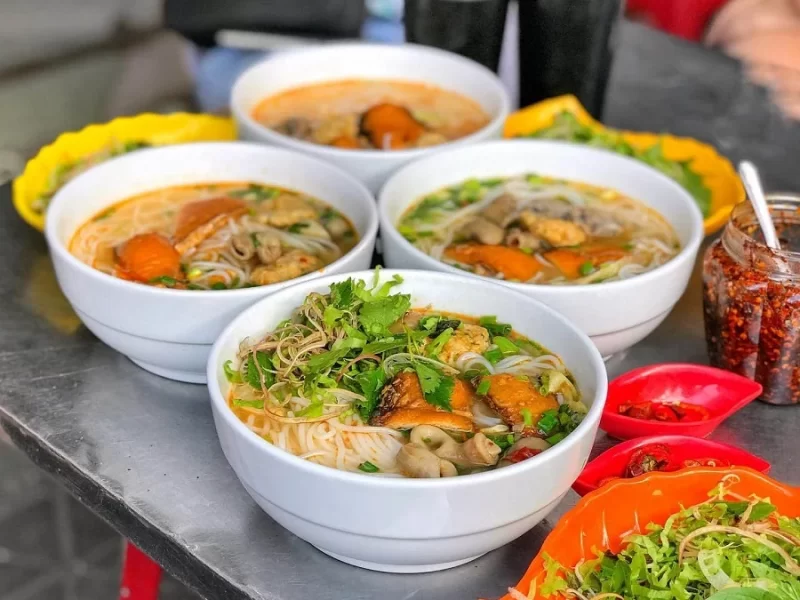 Hai Phong Weather 2024: Essential Guide for Your Trip Bowls of Hai Phong noodle soup with fresh herbs and chili
