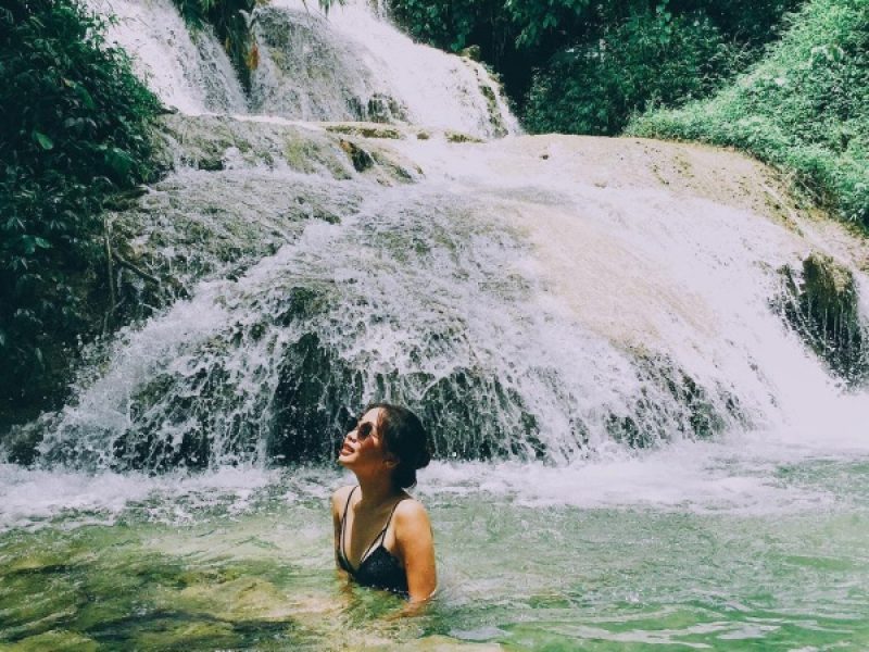 Visitor swimming at the base of Hieu Waterfall in Pu Luong Nature Reserve