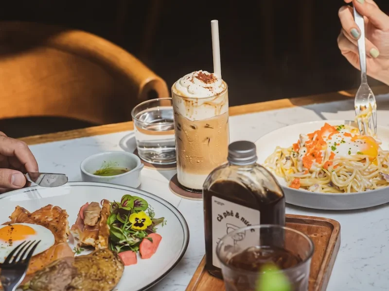 Top 5 Coffee Shops Near St. Joseph's Cathedral Hanoi Spacious industrial-style interior with exposed brick walls and open coffee counter at The Running Bean near St. Joseph's Cathedral Hanoi
