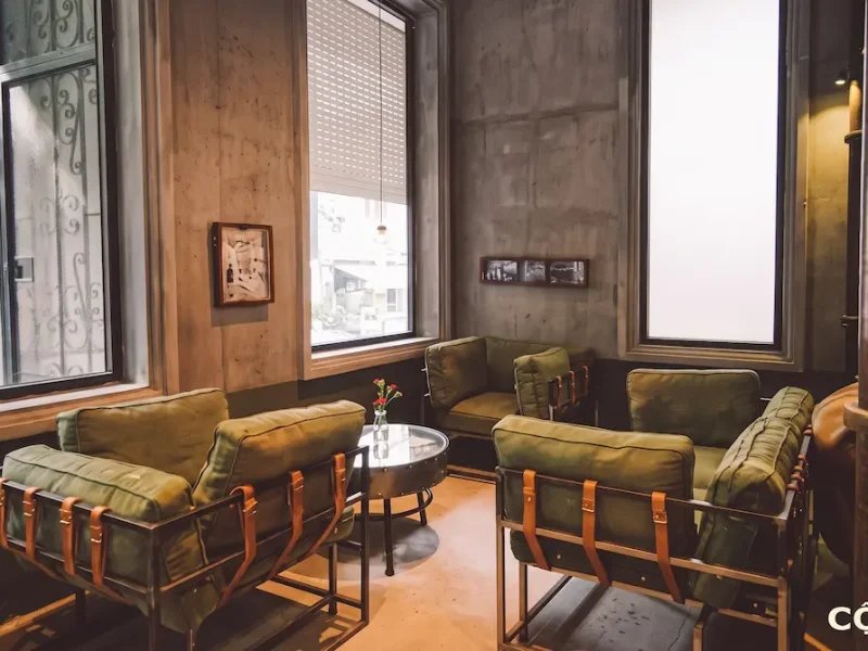 Top 5 Coffee Shops Near St. Joseph's Cathedral Hanoi Rustic subsidy-era interior with green army fabric armchairs and vintage decor inside Cong Caphe near St. Joseph's Cathedral Hanoi