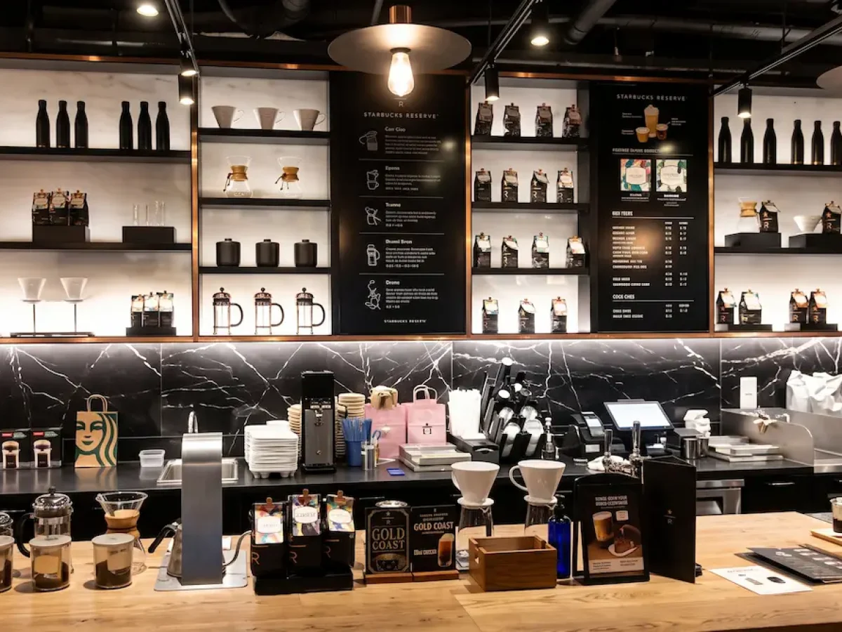 Starbucks Reserve Brew Bar near St. Joseph's Cathedral - Vietnam Discovery Tours Modern Starbucks Reserve brew bar with coffee equipment, menu board, and packaged coffee beans near St. Joseph's Cathedral Hanoi