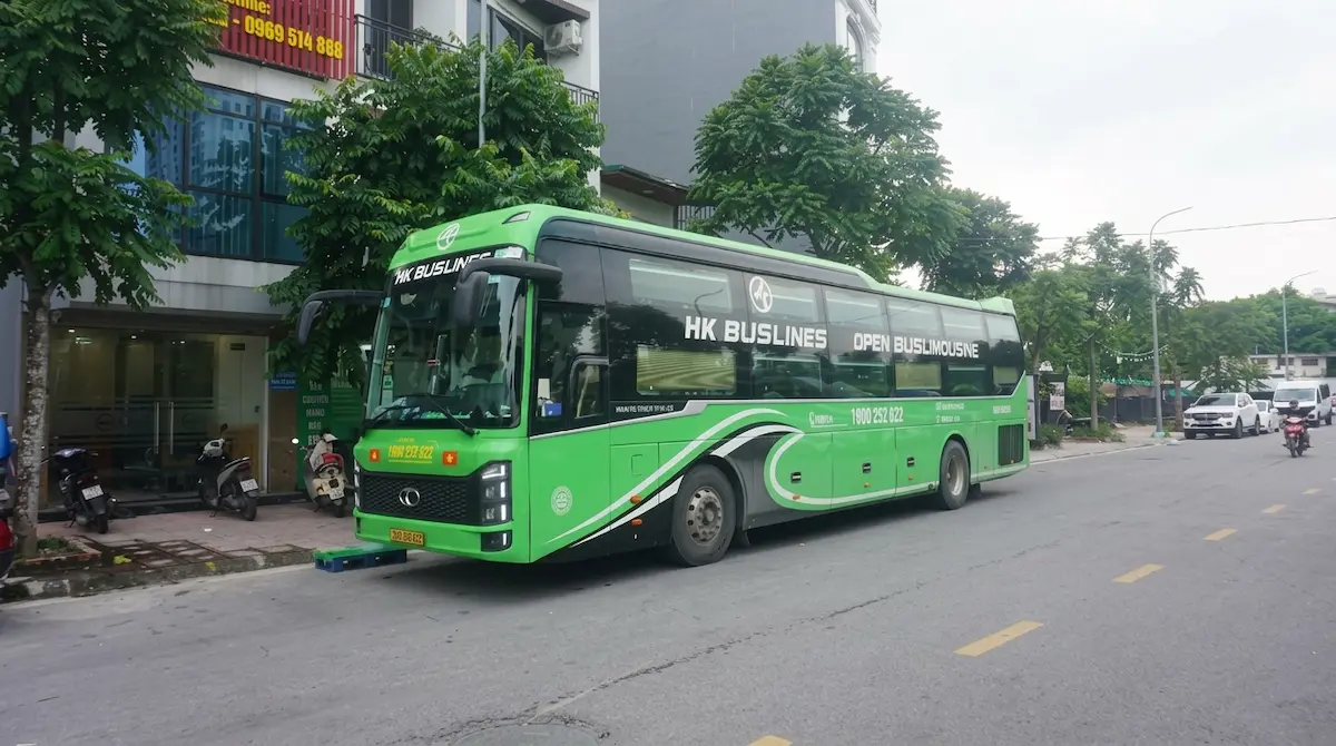 Sapa to Ha Long 22 Cabin VIP Sleeper Bus | Vietnam Discovery Tours Sapa to Ha Long Bay direct VIP sleeper bus, exterior view on city street