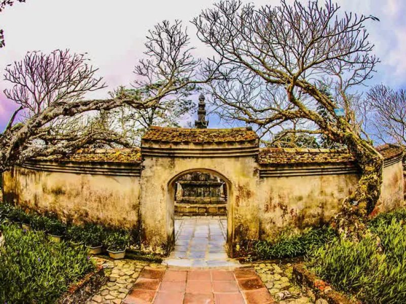 Yen Tu – Vinh Nghiem – Con Son Kiep Bac UNESCO Site Old stone gate and ancient trees at a pagoda in the Yen Tu heritage complex