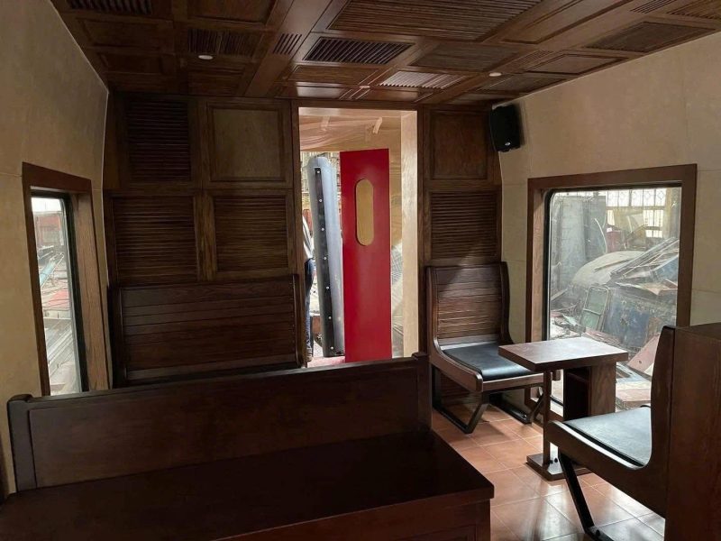 Cozy wooden train cabin with vintage charm.