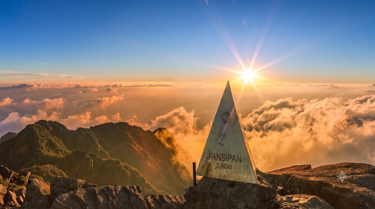 Golden sunrise over Fansipan Peak above a sea of clouds in Sapa