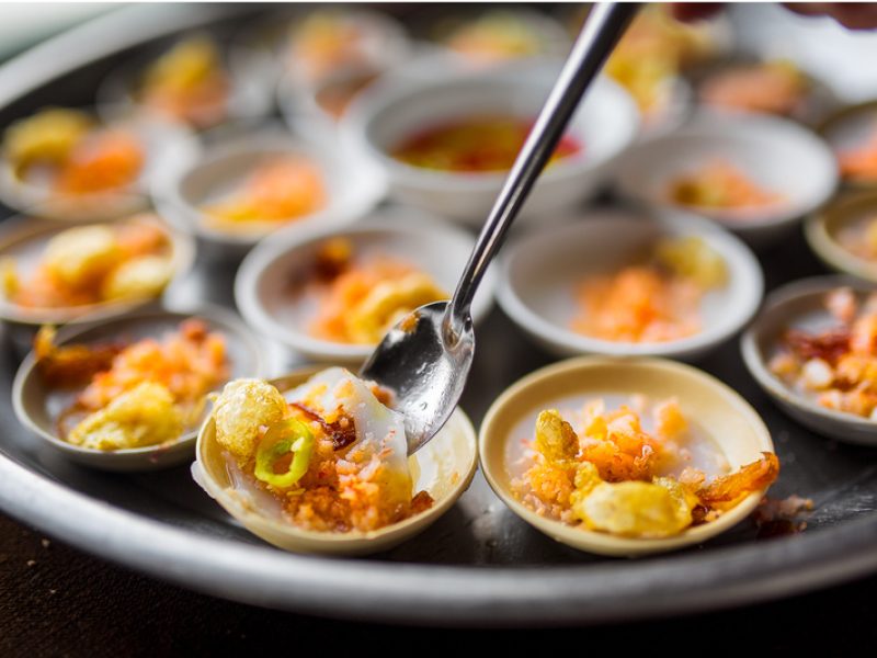 Small dishes of banh beo steamed rice cakes topped with shrimp in Hue