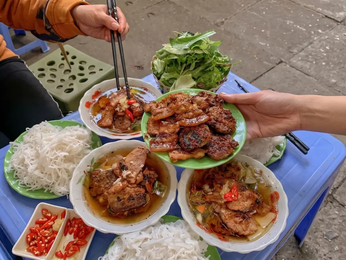 Authentic Hanoi bun cha with grilled pork patties rice noodles and dipping broth by Vietnam Discovery Tours Authentic Hanoi bun cha with grilled pork patties rice noodles and dipping broth by Vietnam Discovery Tours