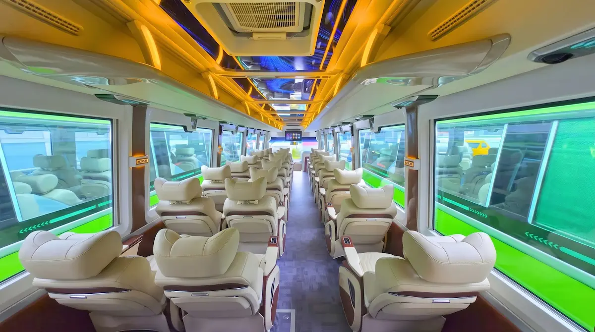 Hanoi to Sapa VIP Limousine Bus Interior View | Vietnam Discovery Tours Back-to-front interior view of VIP limousine bus from Hanoi to Sapa with luxury reclining seats and panoramic windows by Vietnam Discovery Tours