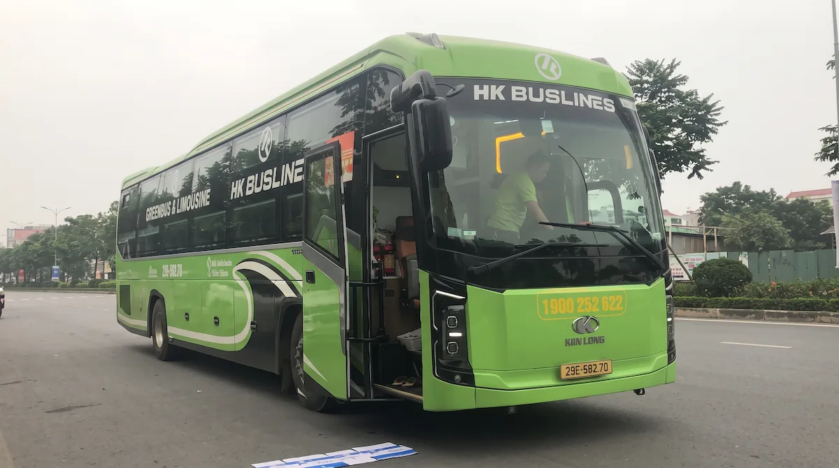 Hanoi to Sapa VIP Limousine Bus | Vietnam Discovery Tours Green HK Buslines VIP limousine sleeper bus with open door preparing for Hanoi to Sapa trip by Vietnam Discovery Tours