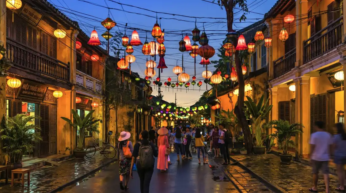 Hoi An Ancient Town Lantern Night | Sleeper Bus from Ha Long Bay | Vietnam Discovery Tours Hoi An Ancient Town at night with colorful silk lanterns glowing over the old street - Vietnam