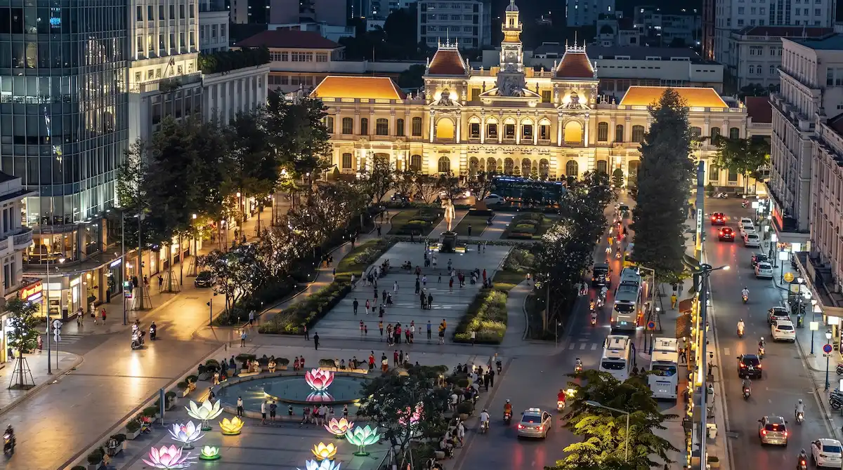 Vibrant night view of Nguyen Hue Walking Street and the iconic City Hall in Saigon, Vietnam