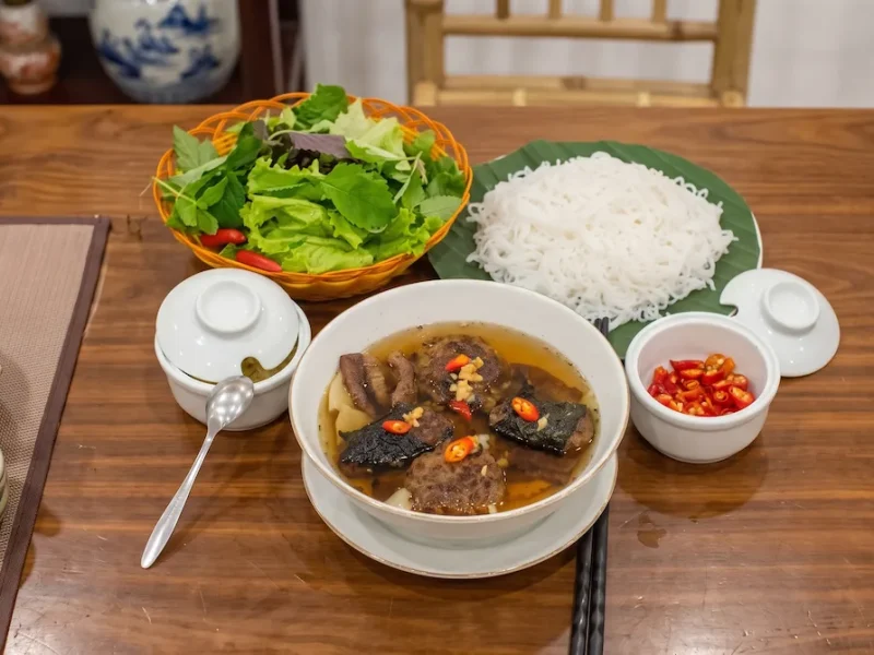 Bun Cha Sinh Tu Meal Set Hanoi - Vietnam Discovery Tours Authentic Bun Cha Sinh Tu meal set served with fresh herbs, noodles, and dipping broth - Vietnam Discovery Tours