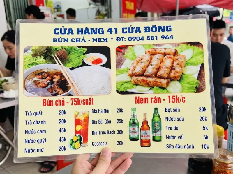 Clear pricing and menu options at Bun Cha 41 Cua Dong, captured during a street food tour by Vietnam Discovery Tours. Menu and drink price list at Bun Cha 41 Cua Dong Hanoi | Vietnam Discovery Tours