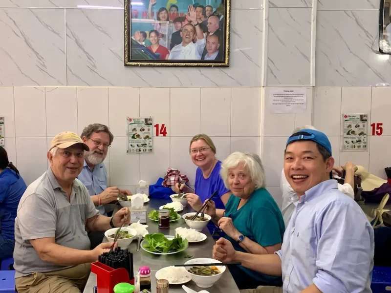 Tourists Dining at Bun Cha Huong Lien - Vietnam Discovery Tours Tourists happily dining together at Bun Cha Huong Lien restaurant in Hanoi - Vietnam Discovery Tours